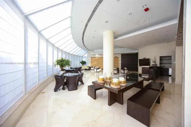 a living room with furniture a wooden floor and next to a window