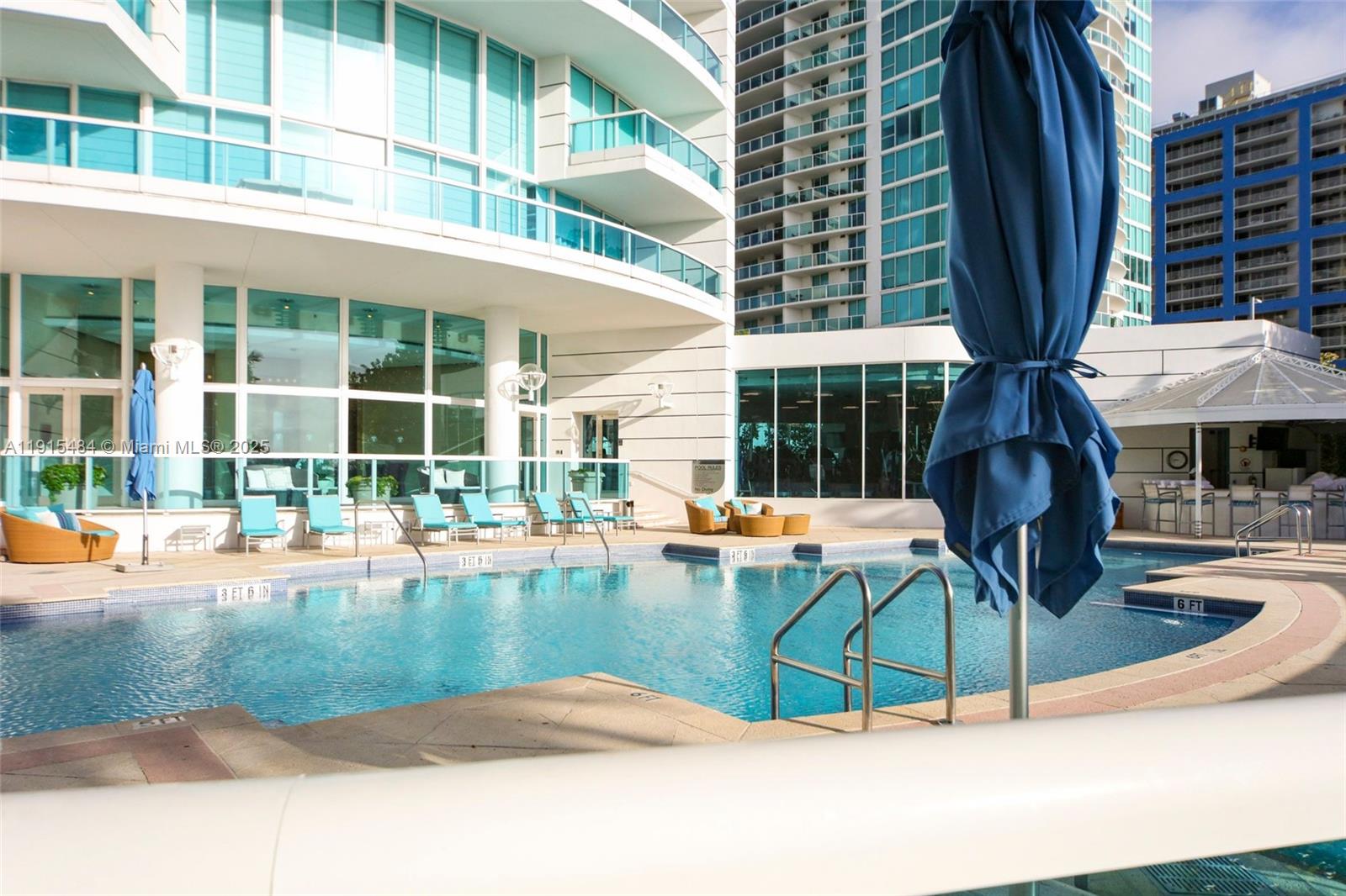2127 Brickell Avenue, Unit 2504 Miami, FL 33129 - Photo 38 of 41 a view of a swimming pool with a lounge chairs