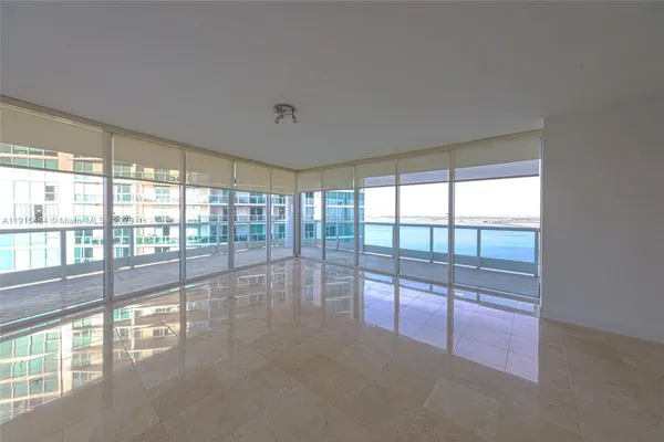 a view of empty room with floor to ceiling window