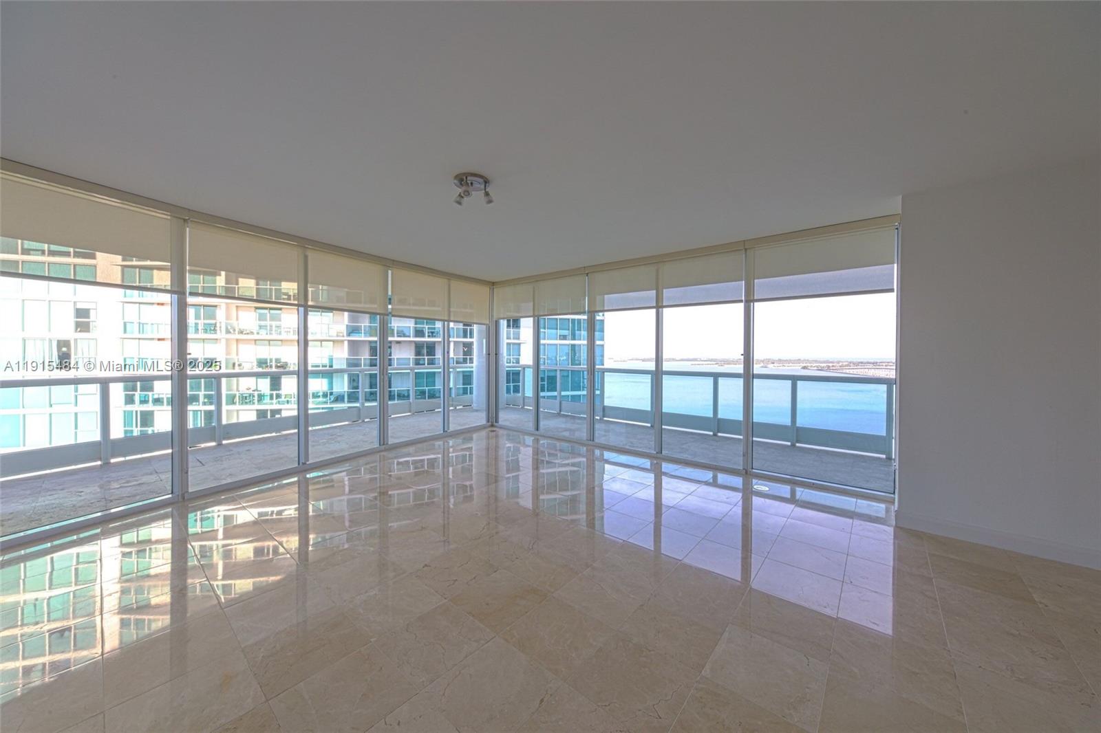 2127 Brickell Avenue, Unit 2504 Miami, FL 33129 - Photo 4 of 41 a view of empty room with floor to ceiling window