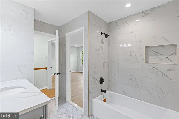 a bathroom with a bathtub and a shower