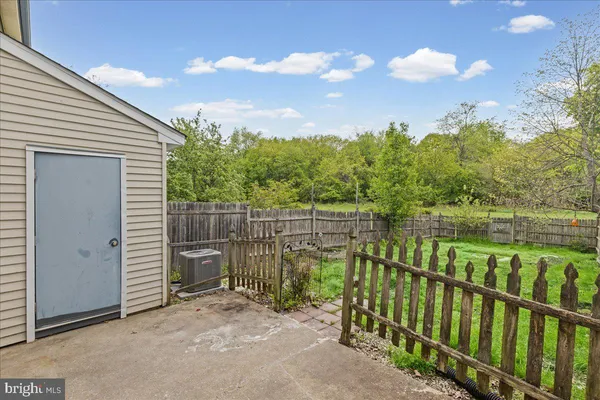 a view of a pathway with a wrought fence