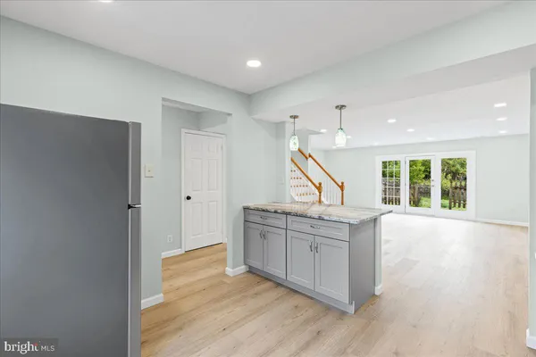 a view of a kitchen with a sink and wooden floor