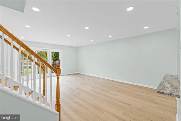 a view of an entryway with wooden floor