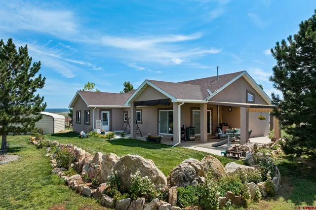 a front view of a house with yard and green space