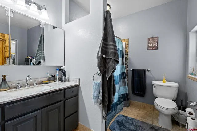 a bathroom with a toilet sink and a mirror