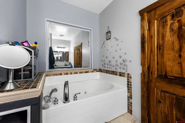 a bathroom with a tub and a shower