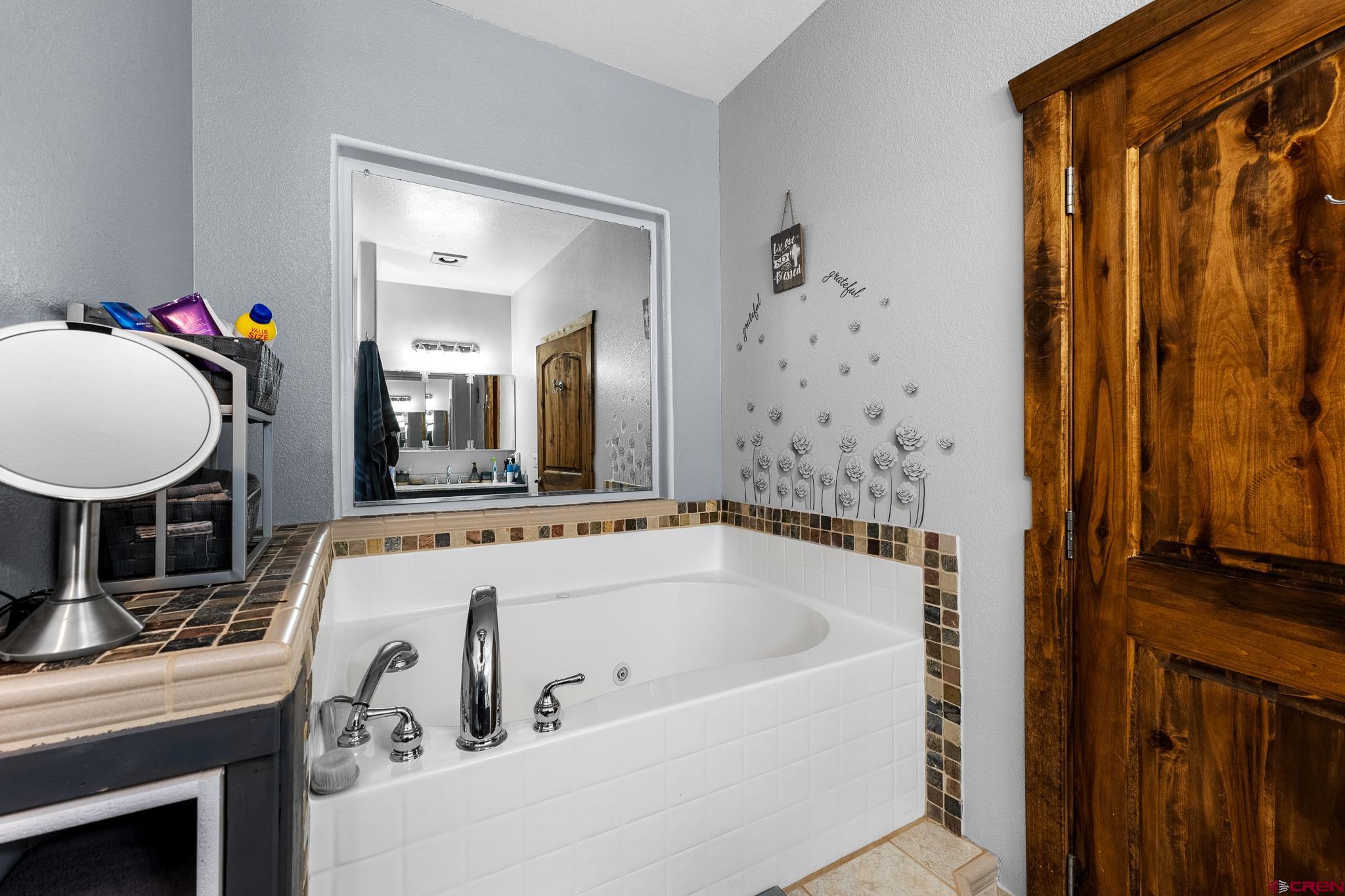 13723 Rd T Cahone, CO 81320 - Photo 17 of 36 a bathroom with a tub and a shower