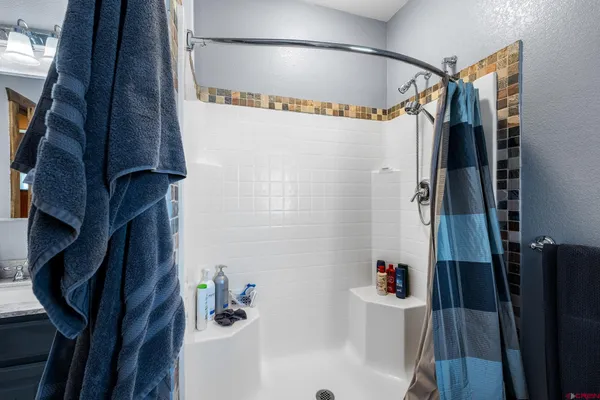 a bathroom with a bathtub and shower
