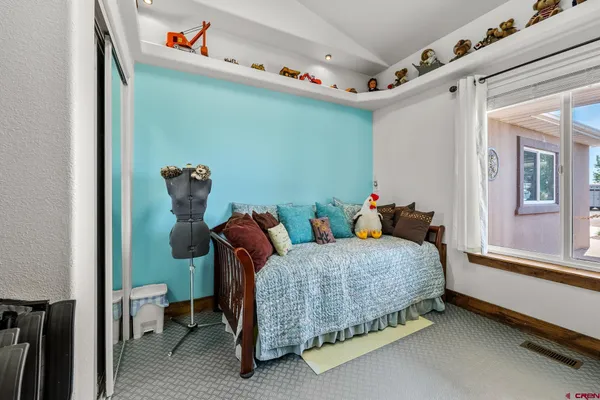 a bedroom with a bed and a window