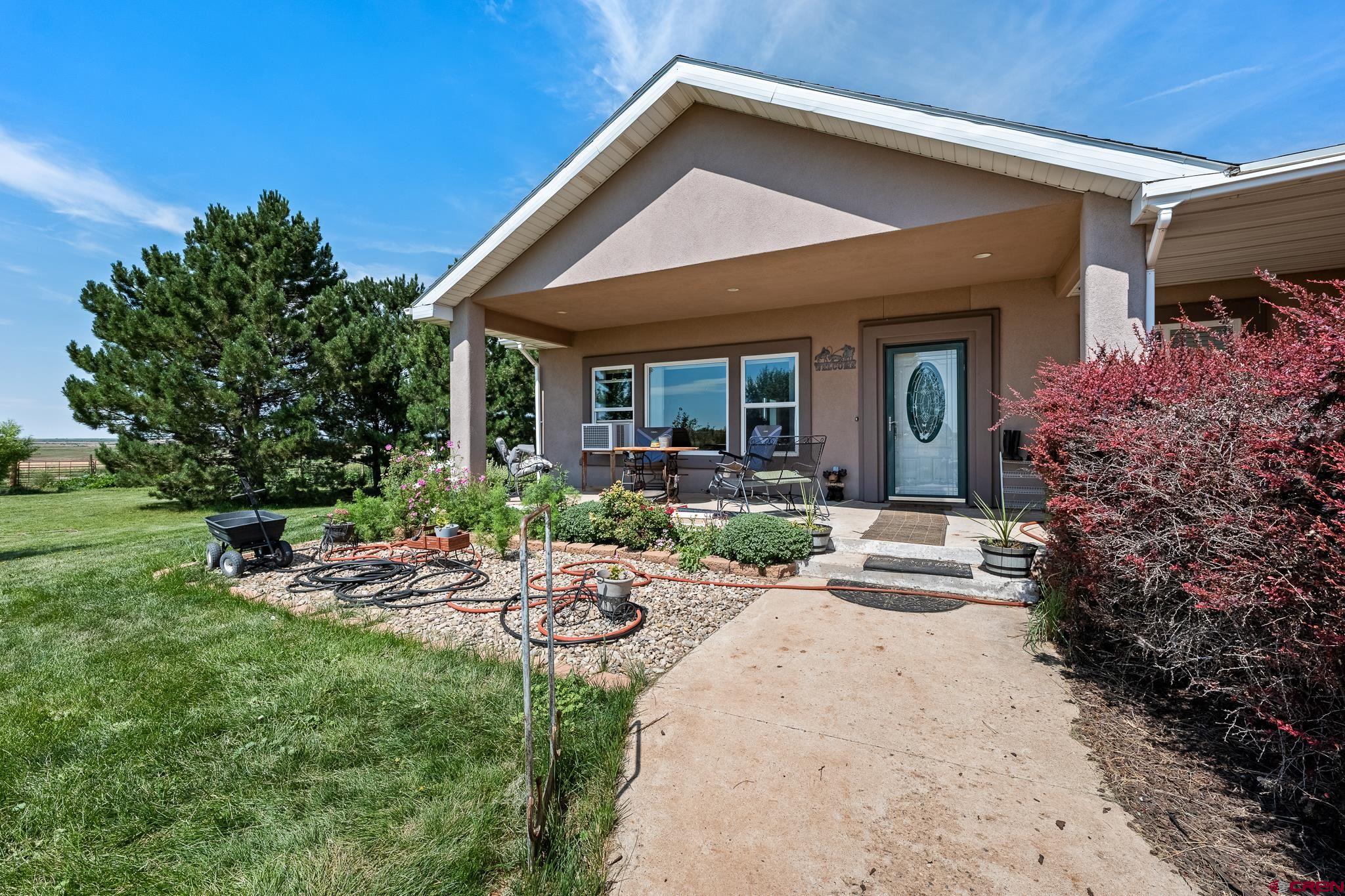13723 Rd T Cahone, CO 81320 - Photo 26 of 36 a view of a house with backyard sitting area and garden