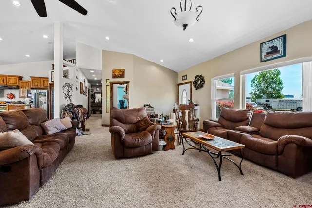 a living room with furniture ceiling fan and a rug