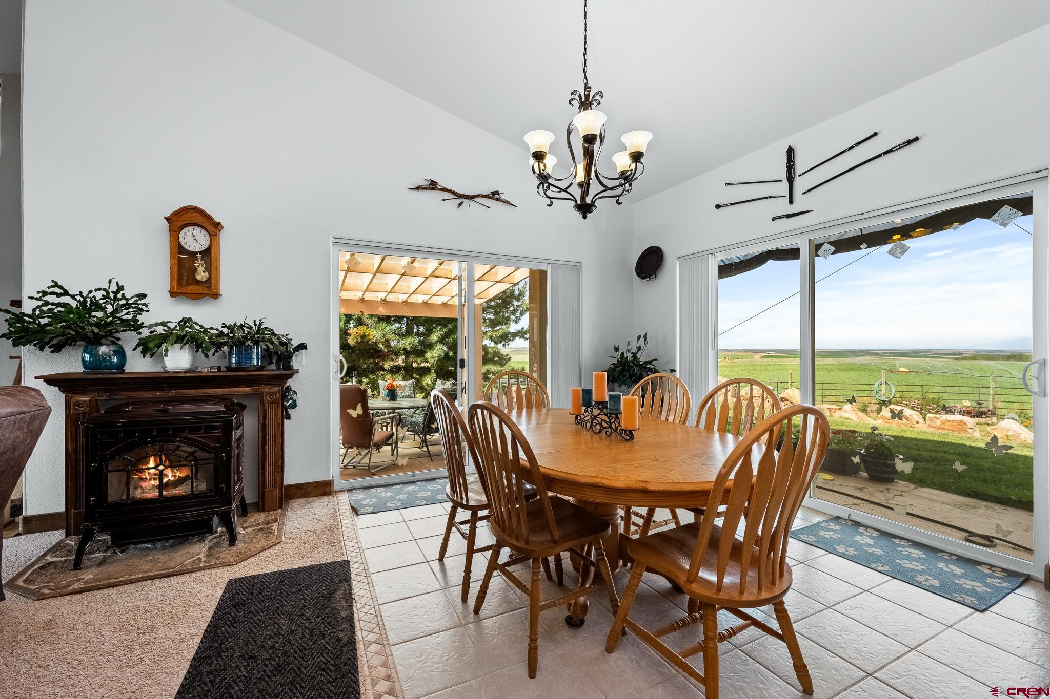 13723 Rd T Cahone, CO 81320 - Photo 6 of 36 a dining room with furniture a fireplace and large windows