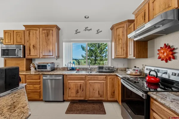 a kitchen with a sink stove top oven and cabinets