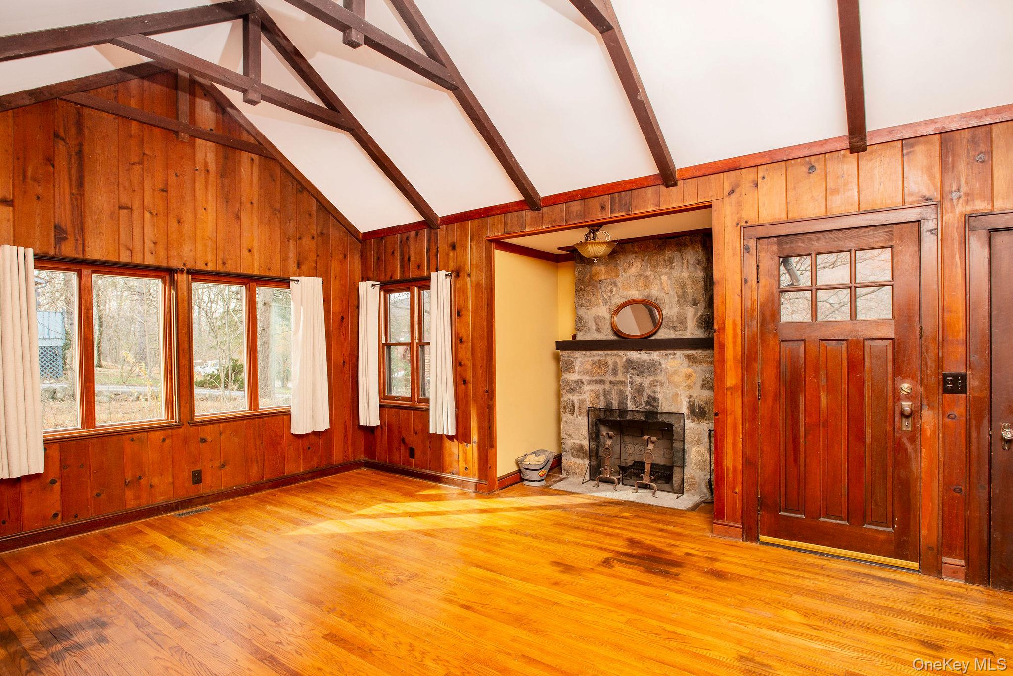 11 Locust Drive Cold Spring, NY 10516 - Photo 2 of 20 Carefully restored great room, with wood burning fireplace, wood paneling, tall ceilings and beams.