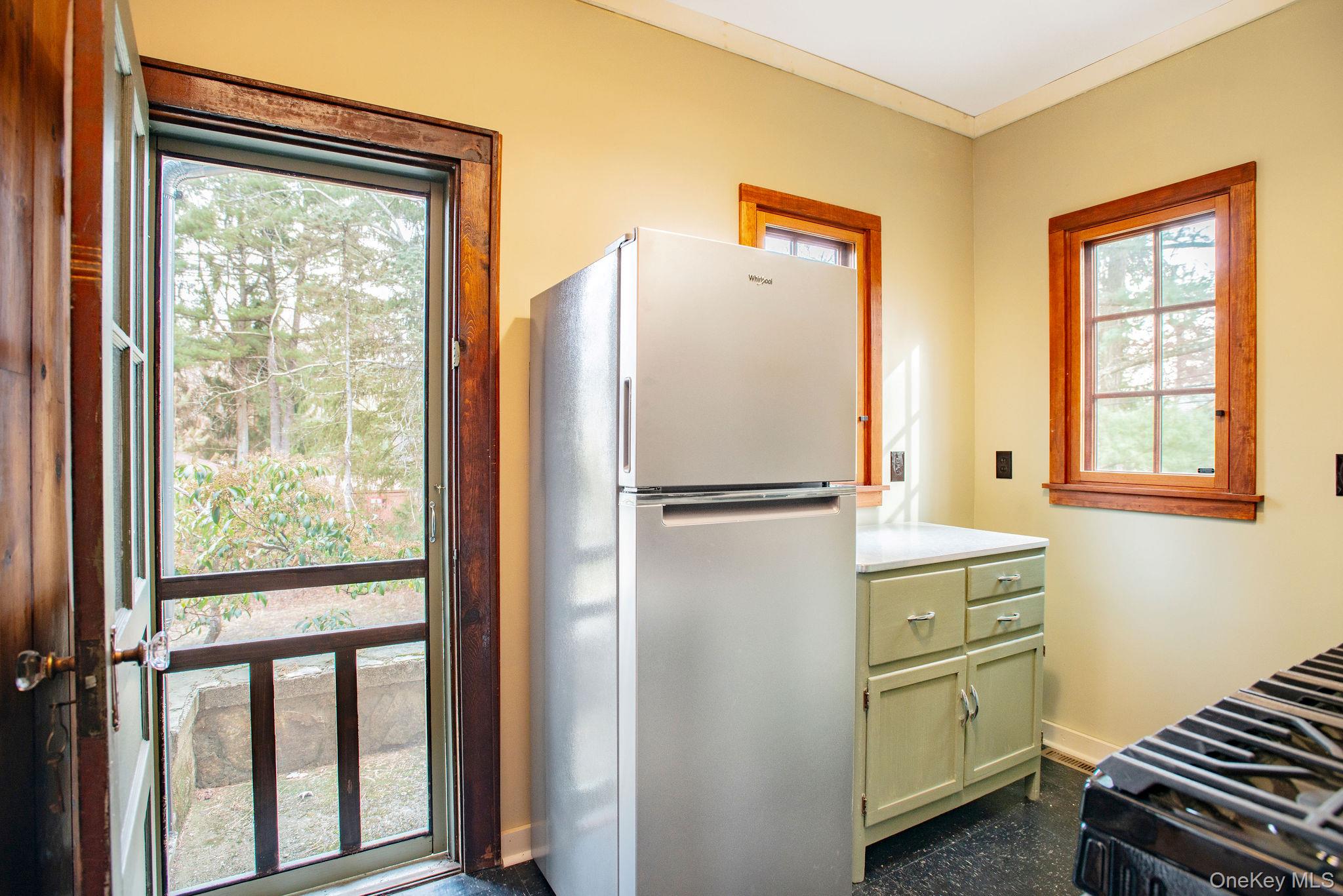 11 Locust Drive Cold Spring, NY 10516 - Photo 8 of 20 Kitchen with gas stove and microwave, leading to back yard.