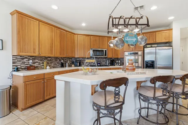 a kitchen with stainless steel appliances and cabinets