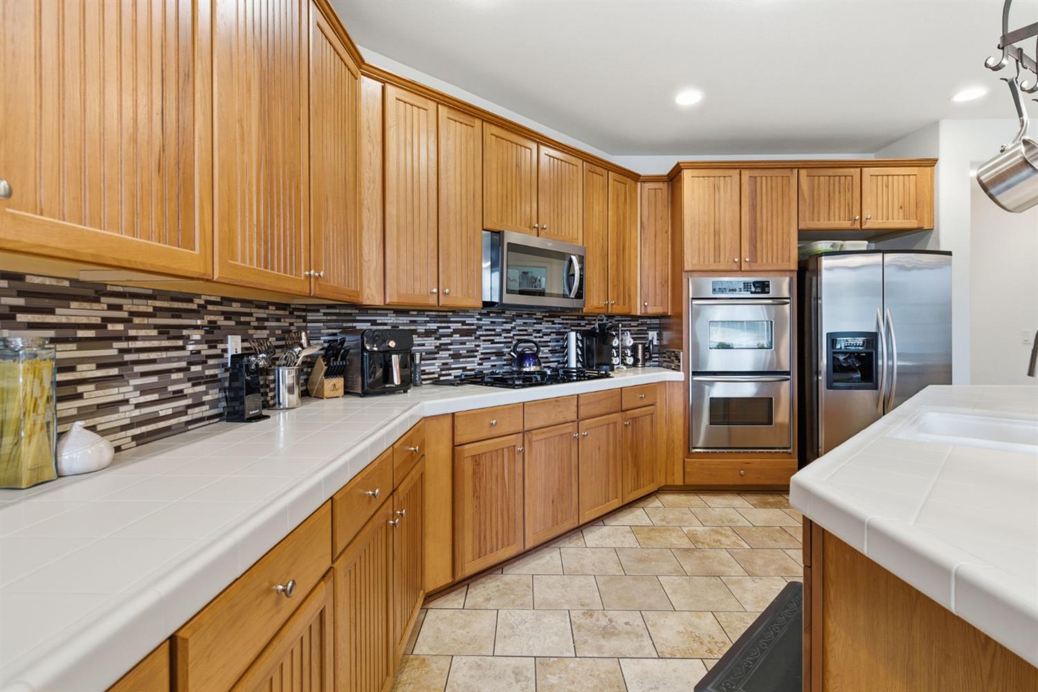 1806 West Ripon Road Ripon, CA 95366 - Photo 20 of 65 a kitchen with stainless steel appliances a refrigerator sink and cabinets