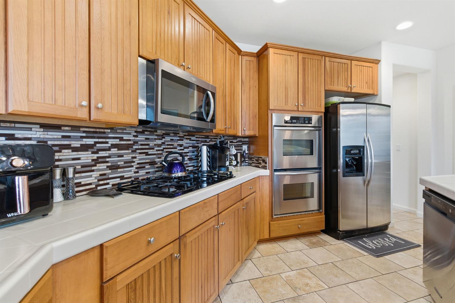 1806 West Ripon Road Ripon, CA 95366 - Photo 22 of 65 a kitchen with stainless steel appliances and cabinets