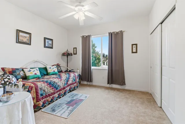 a spacious bedroom with a bed and a large window