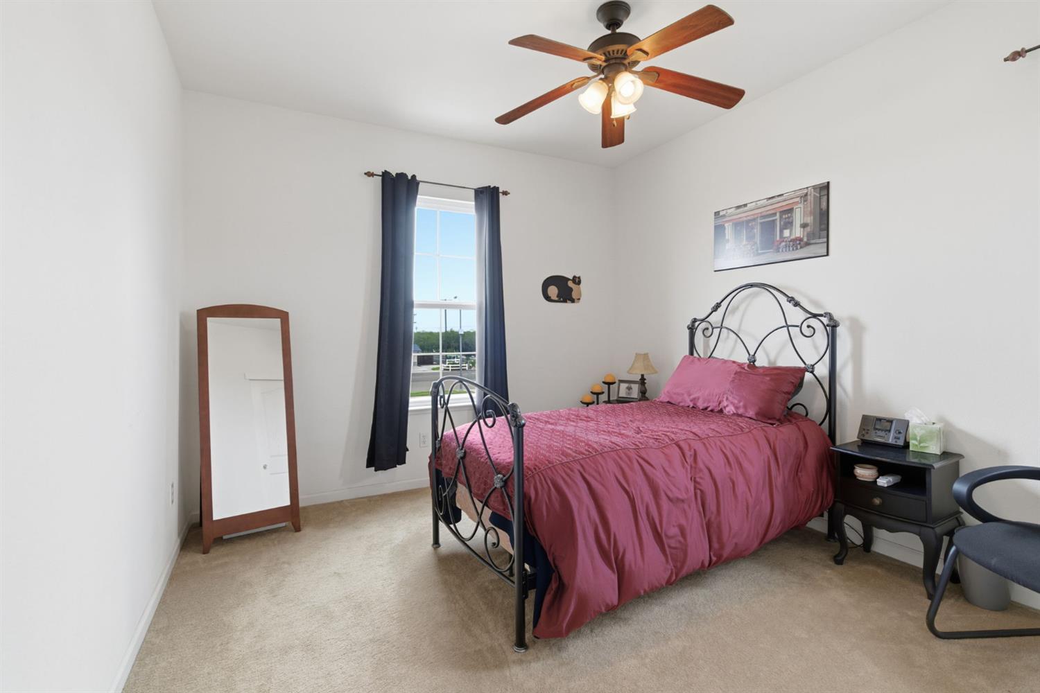 1806 West Ripon Road Ripon, CA 95366 - Photo 37 of 65 a bedroom with a bed and a chandelier