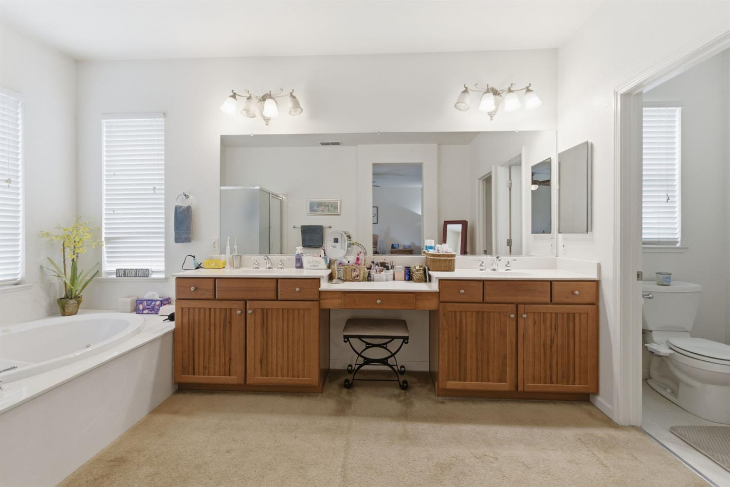 1806 West Ripon Road Ripon, CA 95366 - Photo 42 of 65 a spacious bathroom with a double vanity sink a mirror a bathtub and a toilet