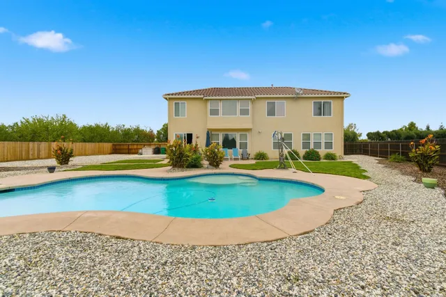 an aerial view of a house with outdoor space