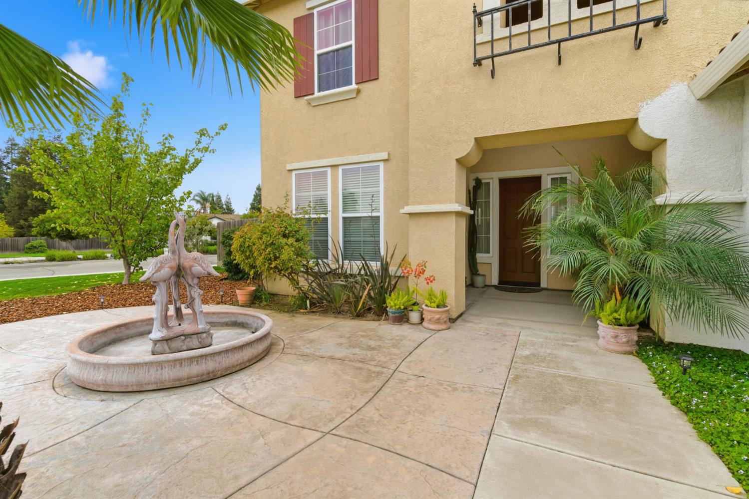 1806 West Ripon Road Ripon, CA 95366 - Photo 6 of 65 a view of a house with a fountain and plants