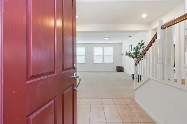 a view of livingroom with furniture and a refrigerator