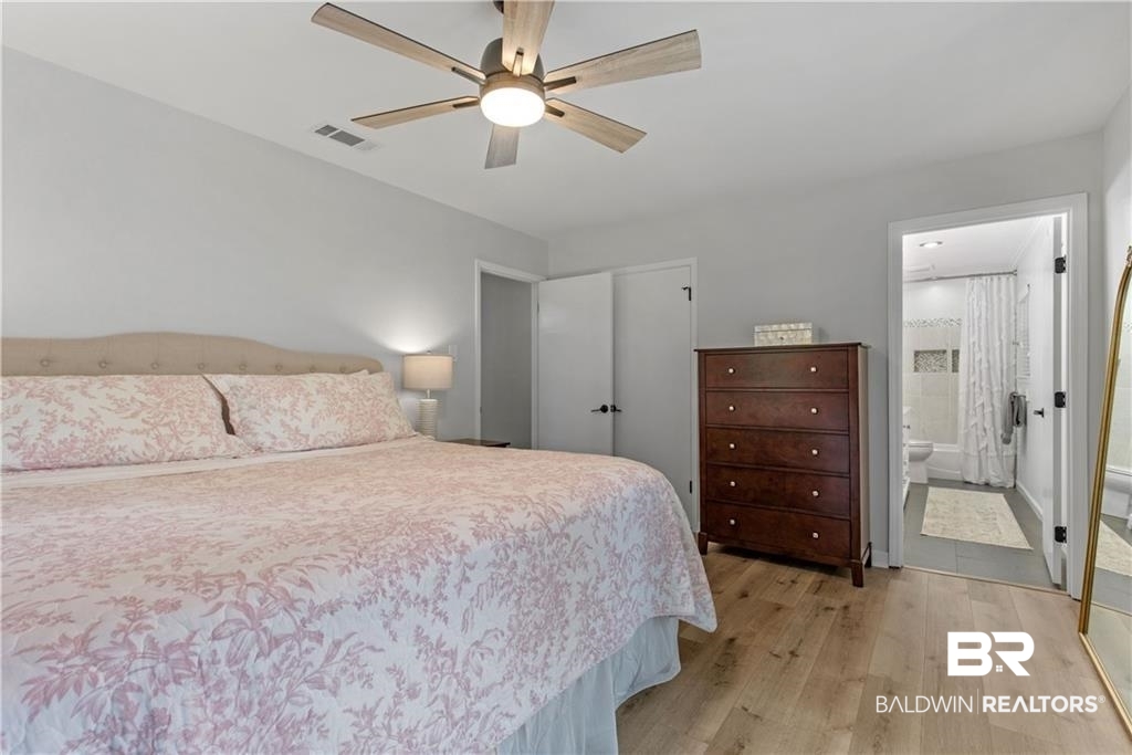 1624 Apex Drive Mobile, AL 36693 - Photo 23 of 29 Bedroom with light hardwood / wood-style flooring, ensuite bath, and ceiling fan