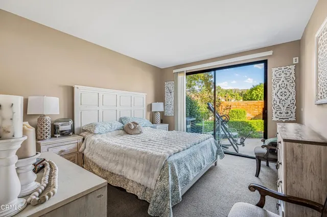 a bedroom with a bed window and a table