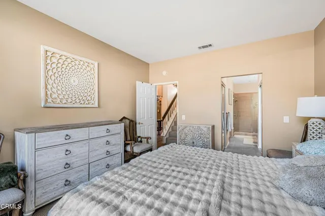 a bedroom with a bed and a dresser