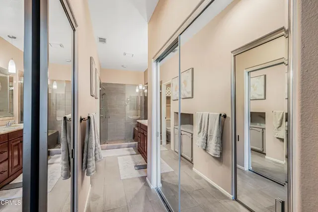 a bathroom with a glass shower door and a mirror