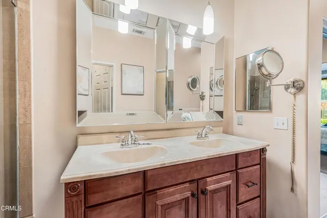 a bathroom with a sink double vanity and a mirror