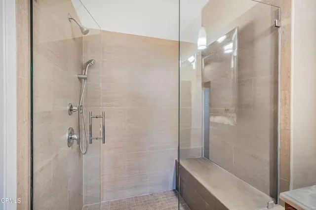 a bathroom with a shower and a sink