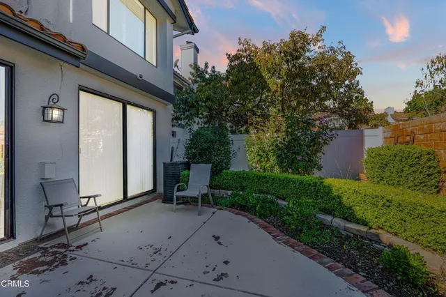 a view of backyard with plants and outdoor seating