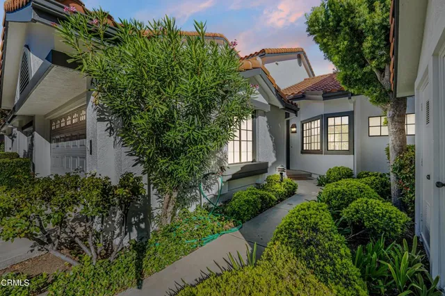 a front view of a house with garden