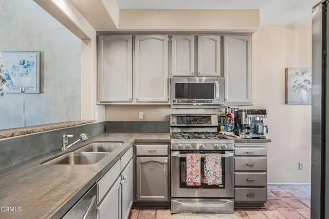 a kitchen with stainless steel appliances granite countertop a stove and a sink