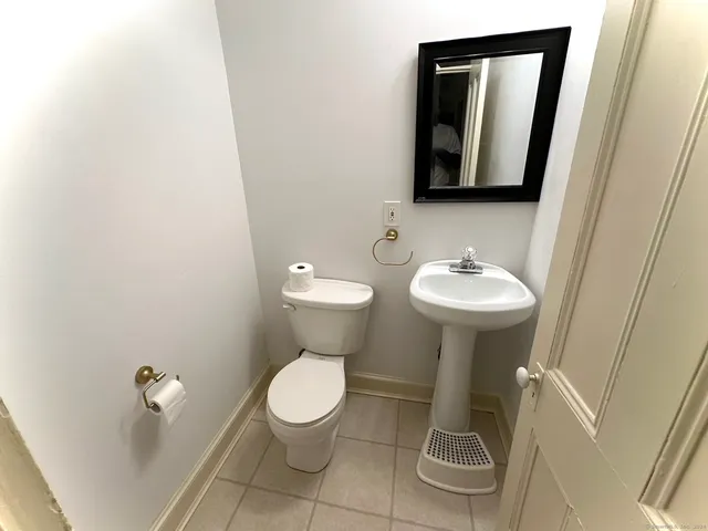 a white toilet sitting next to a white sink
