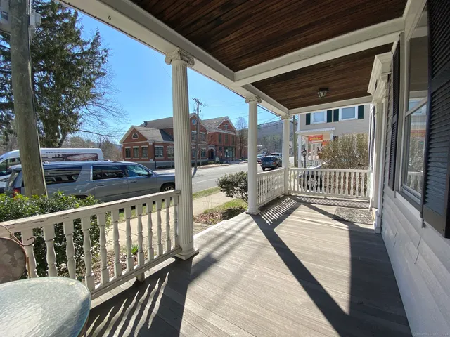 a view of balcony with a large window and wooden floor