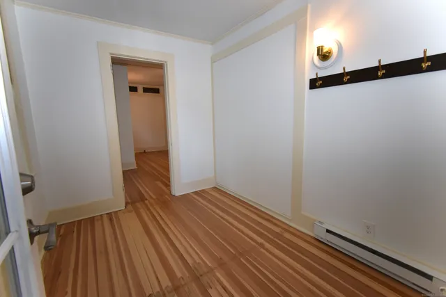 a view of hallway with wooden floor