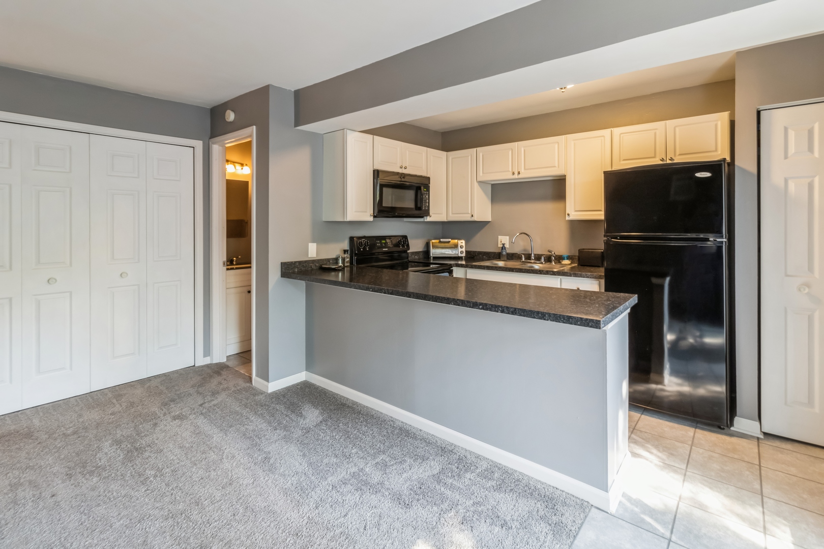 20 St Thomas Colony Street, Unit 7 Fox Lake, IL 60020 - Photo 6 of 15 a kitchen with a refrigerator and a stove top oven