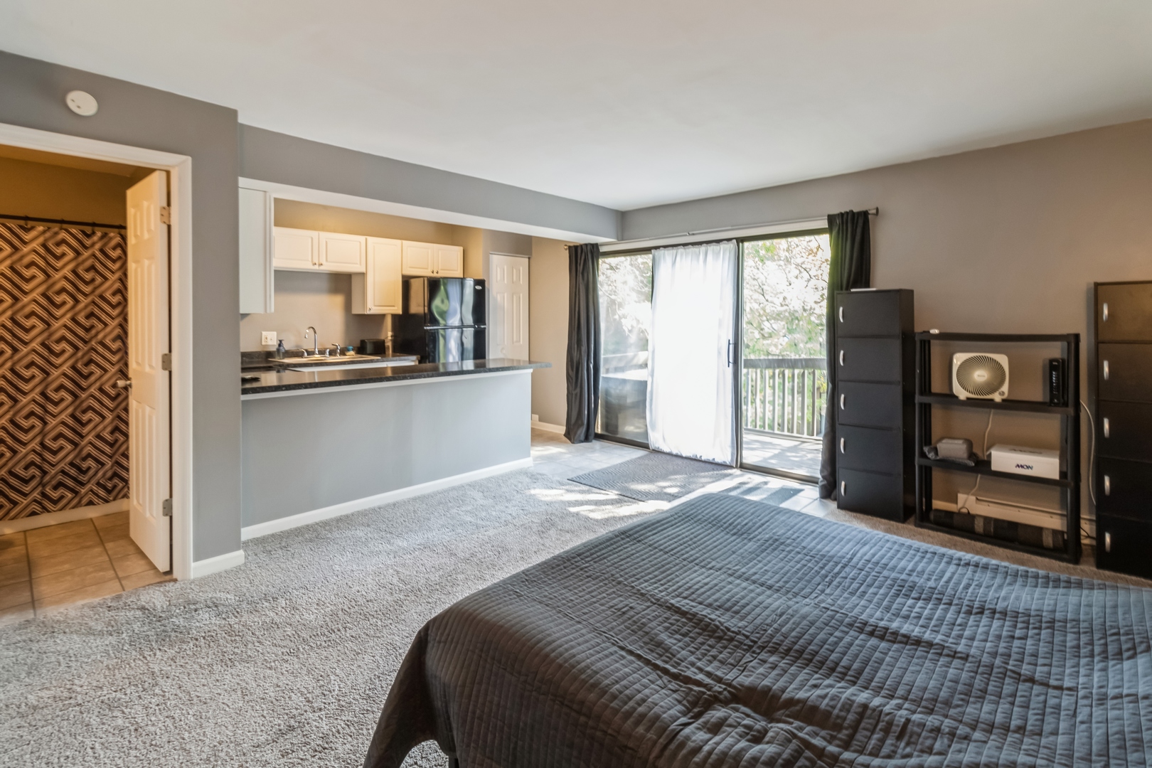 20 St Thomas Colony Street, Unit 7 Fox Lake, IL 60020 - Photo 7 of 15 a bedroom with a bed and large windows