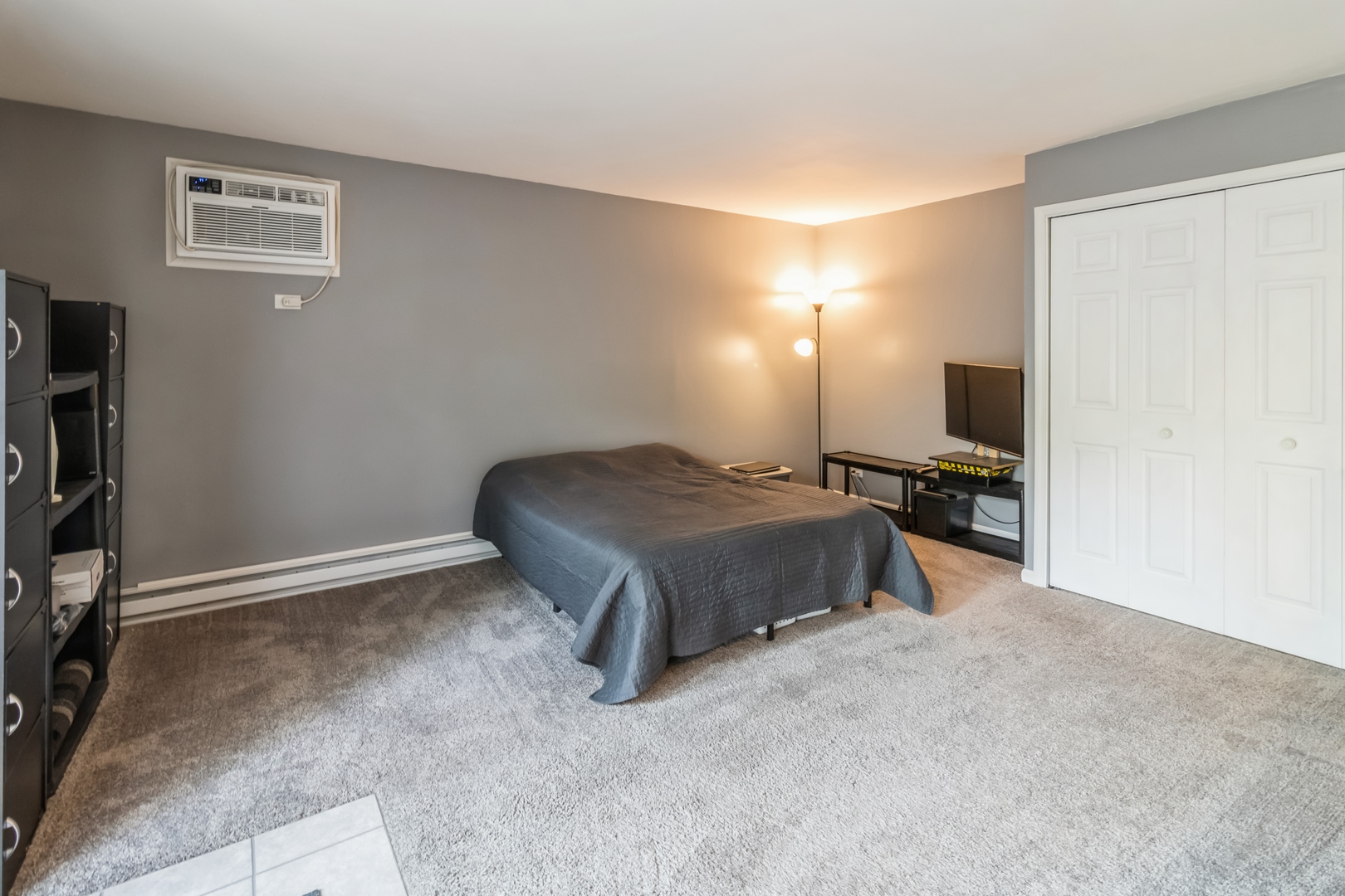 20 St Thomas Colony Street, Unit 7 Fox Lake, IL 60020 - Photo 8 of 15 a bedroom with a bed and a tv on table