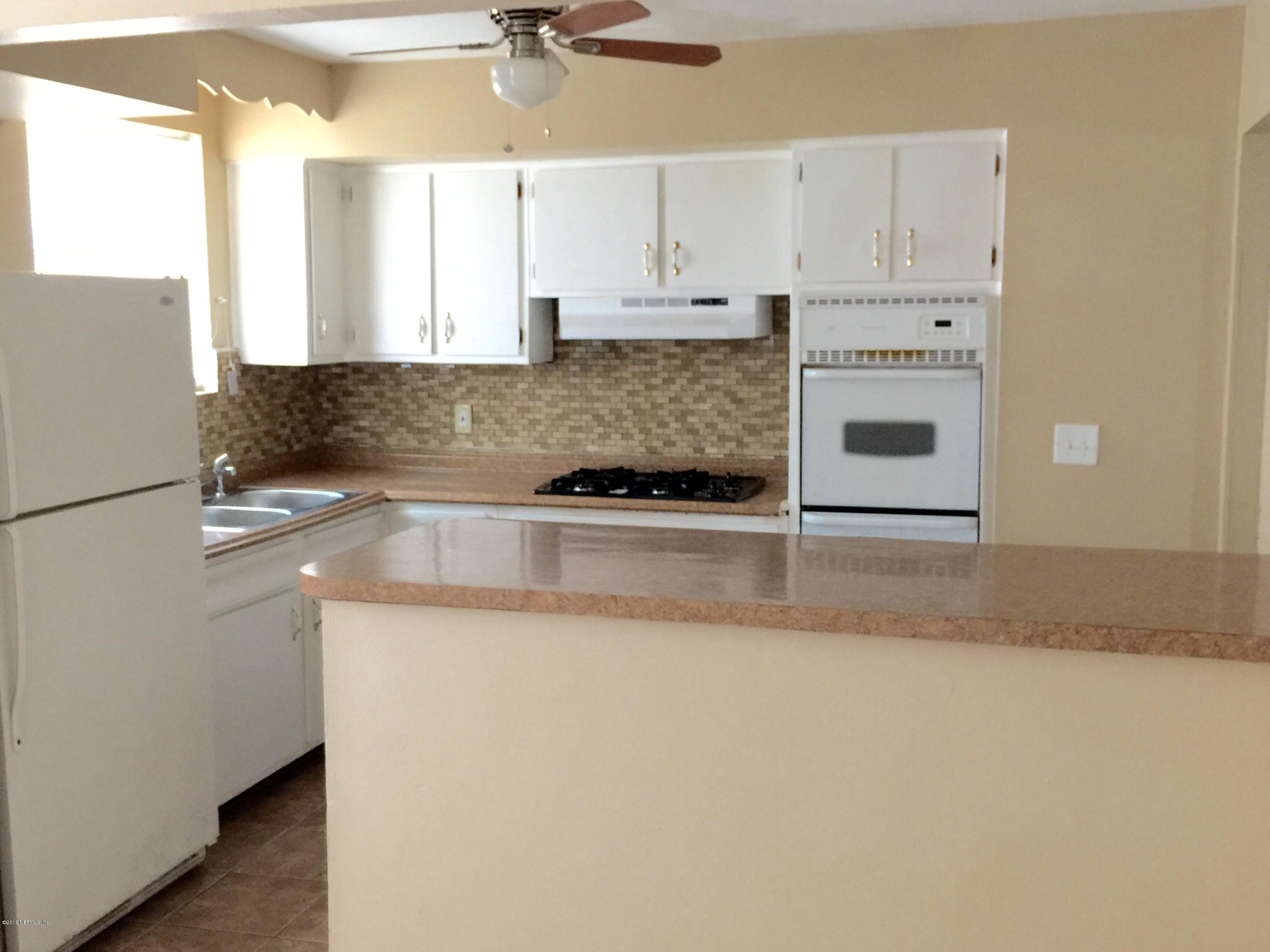 6121 Anvil Road Jacksonville, FL 32277 - Photo 8 of 31 a kitchen with granite countertop a sink and a stove top oven