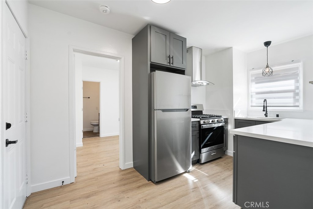 411-417 North Euclid Avenue Pasadena, CA 91101 - Photo 22 of 40 a kitchen with kitchen island a counter top space and stainless steel appliances