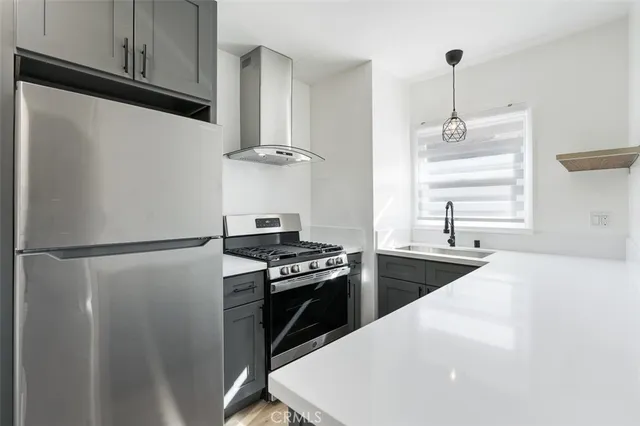 a stove top oven sitting inside of a kitchen