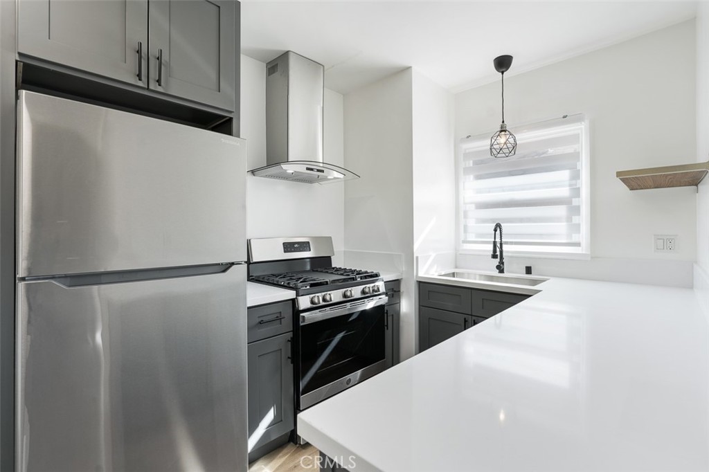 411-417 North Euclid Avenue Pasadena, CA 91101 - Photo 23 of 40 a kitchen with a refrigerator and a stove