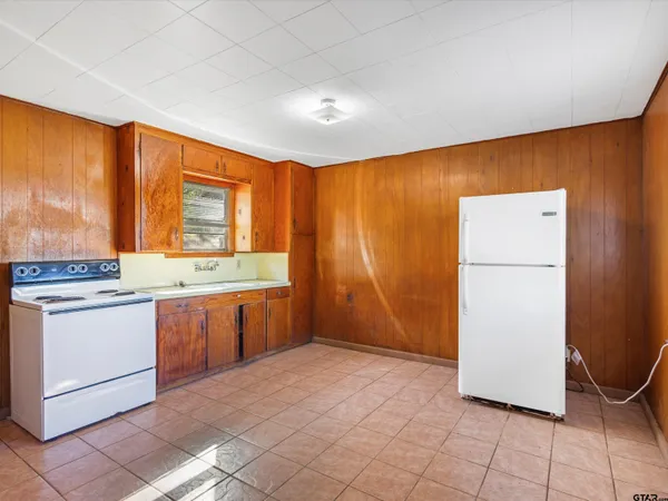 a kitchen with a refrigerator and a stove