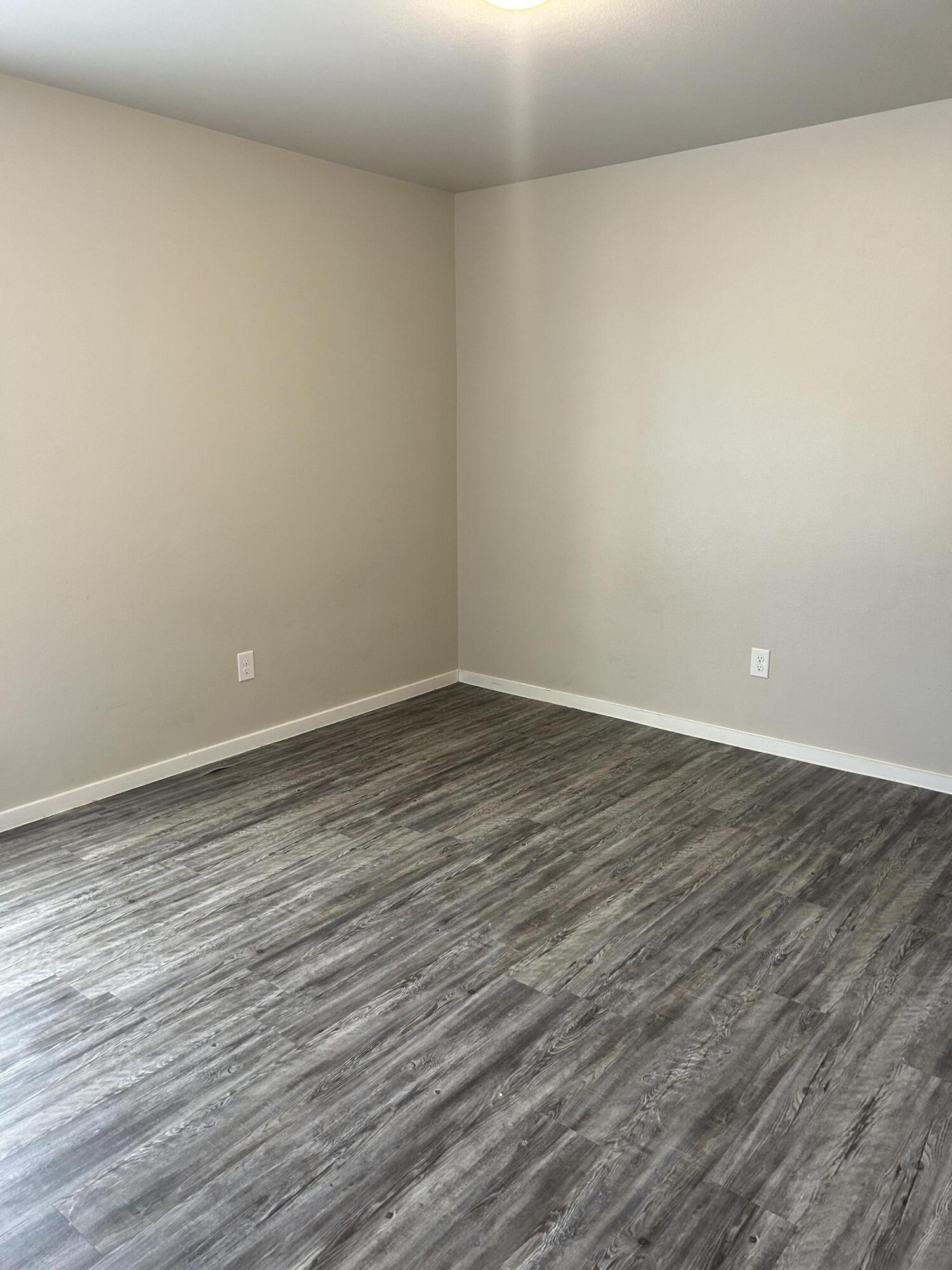 2122 North Texas Avenue Lubbock, TX 79403 - Photo 4 of 7 a view of an empty room with wooden floor